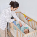 Baby in crib and mom